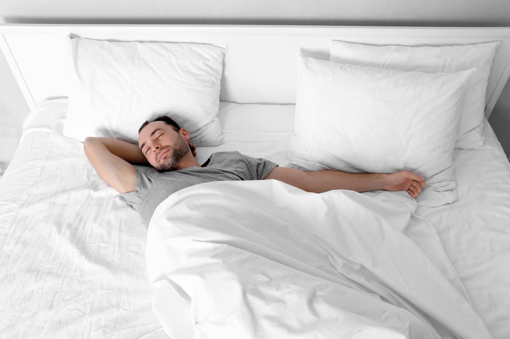 Man sleeping alone in bed