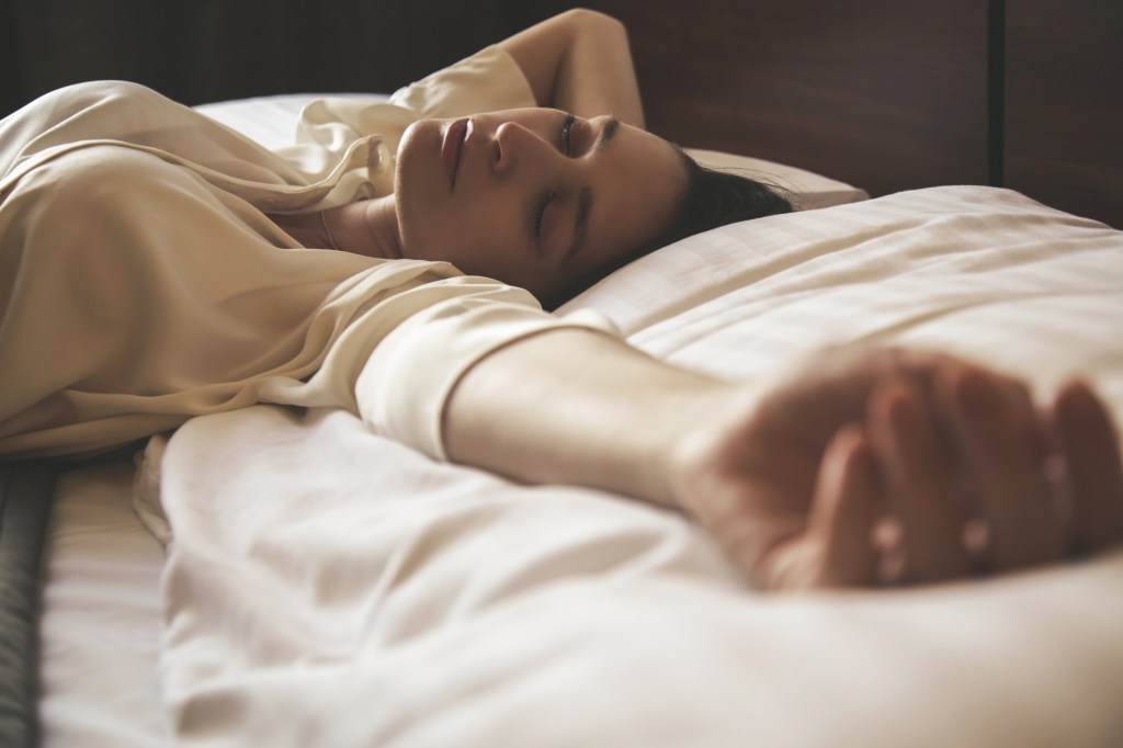 Young woman sleeping on her side in a candid style