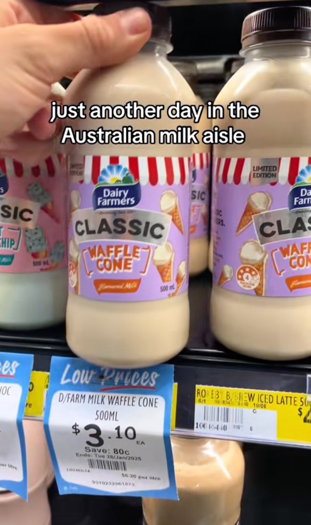 A tikoler displaying a variety of milk bottles with unique flavor at an Australian grocery store