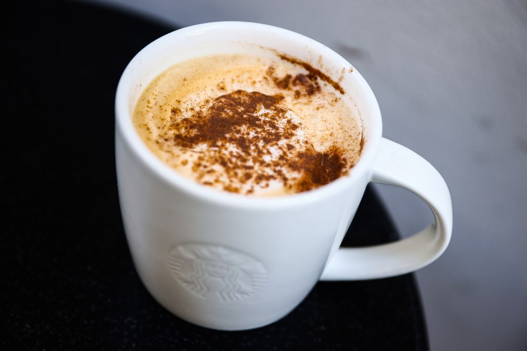 Spice Pumpkin Latte with a foaming surface served at Cafe Starbucks in Krakow, Poland on October 22 2024