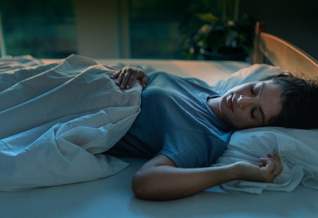 Woman sleeping alone in bed