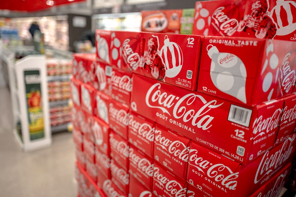 American brand Soda displayed at a Montreal Food Store, Canada, with news about US President Donald Trump's tariff decisions in 2025