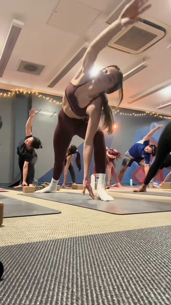 A group of people participating in the first hot grade of Charinlondon's yoga intended to inspire self-improvement