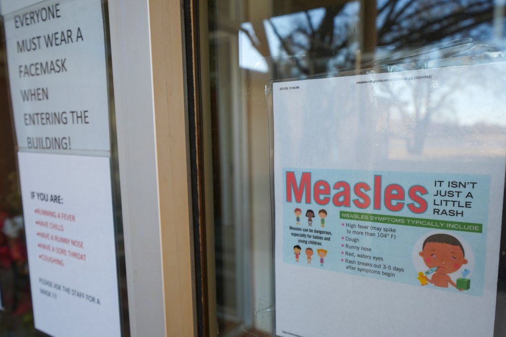 Sign outside a South Plains Public Health County Clinic in Brownfield, Texas, warning of a measles explosion