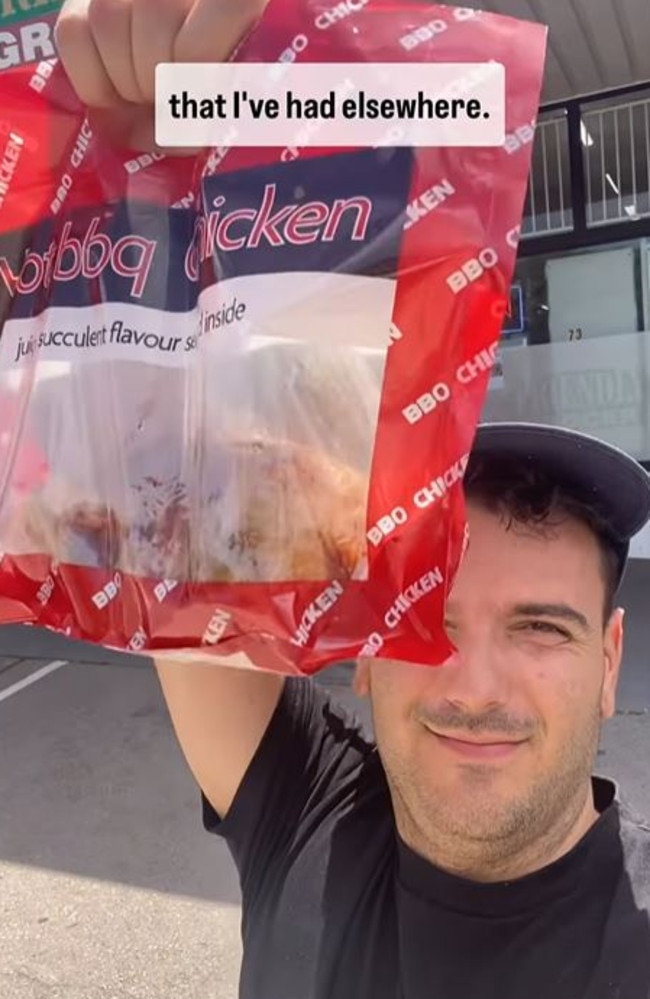 The man holding a ripe chicken bag