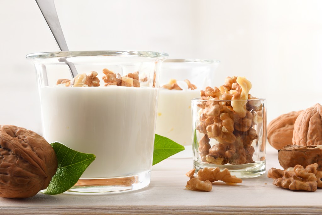 Parts of nuts with natural yogurt.