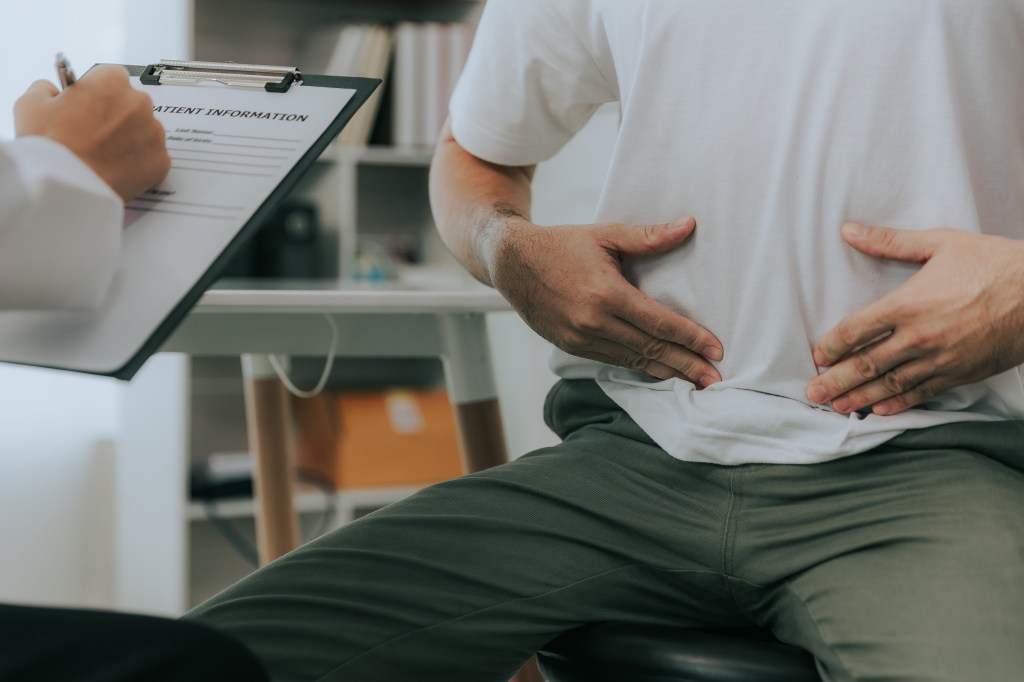 Man with stomach problems in the doctor's office
