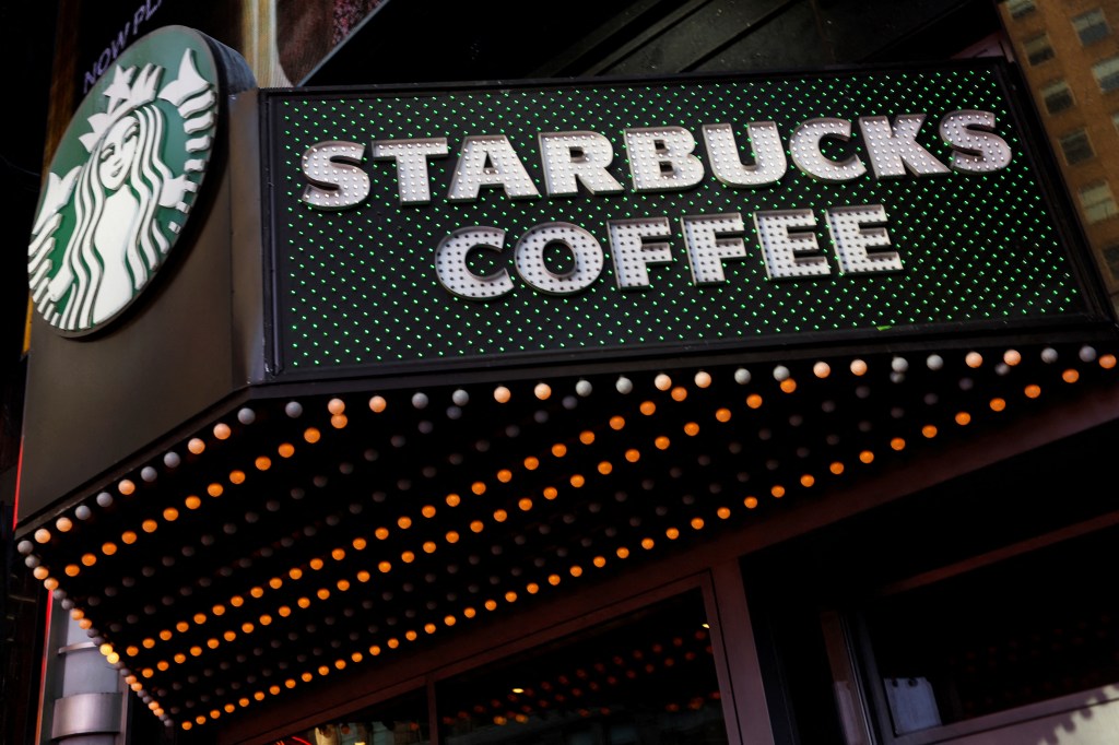 Starbucks Sign in Shop at the Times Square store in New York City