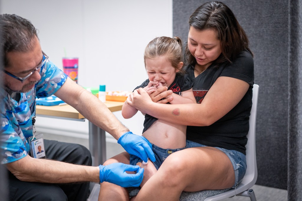 Toddler taking an MMR vaccine in Texas
